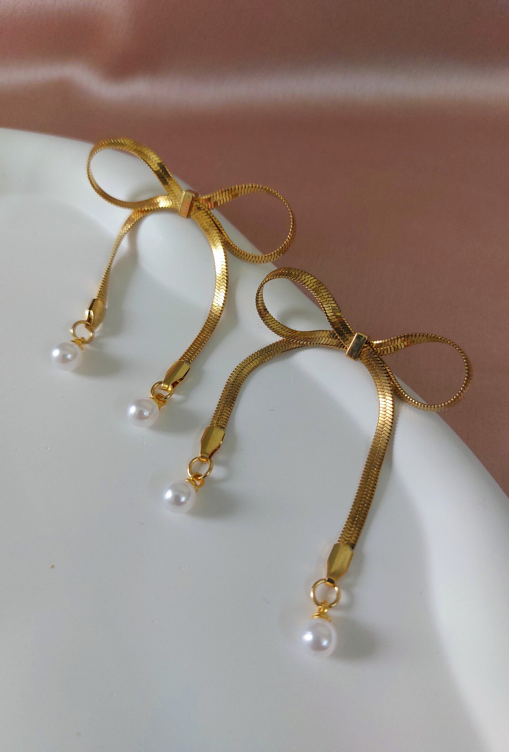 Kimaya Bow Shaped Pearl Studded Gold Plated Anti Tarnish Korean Style Western Earrings