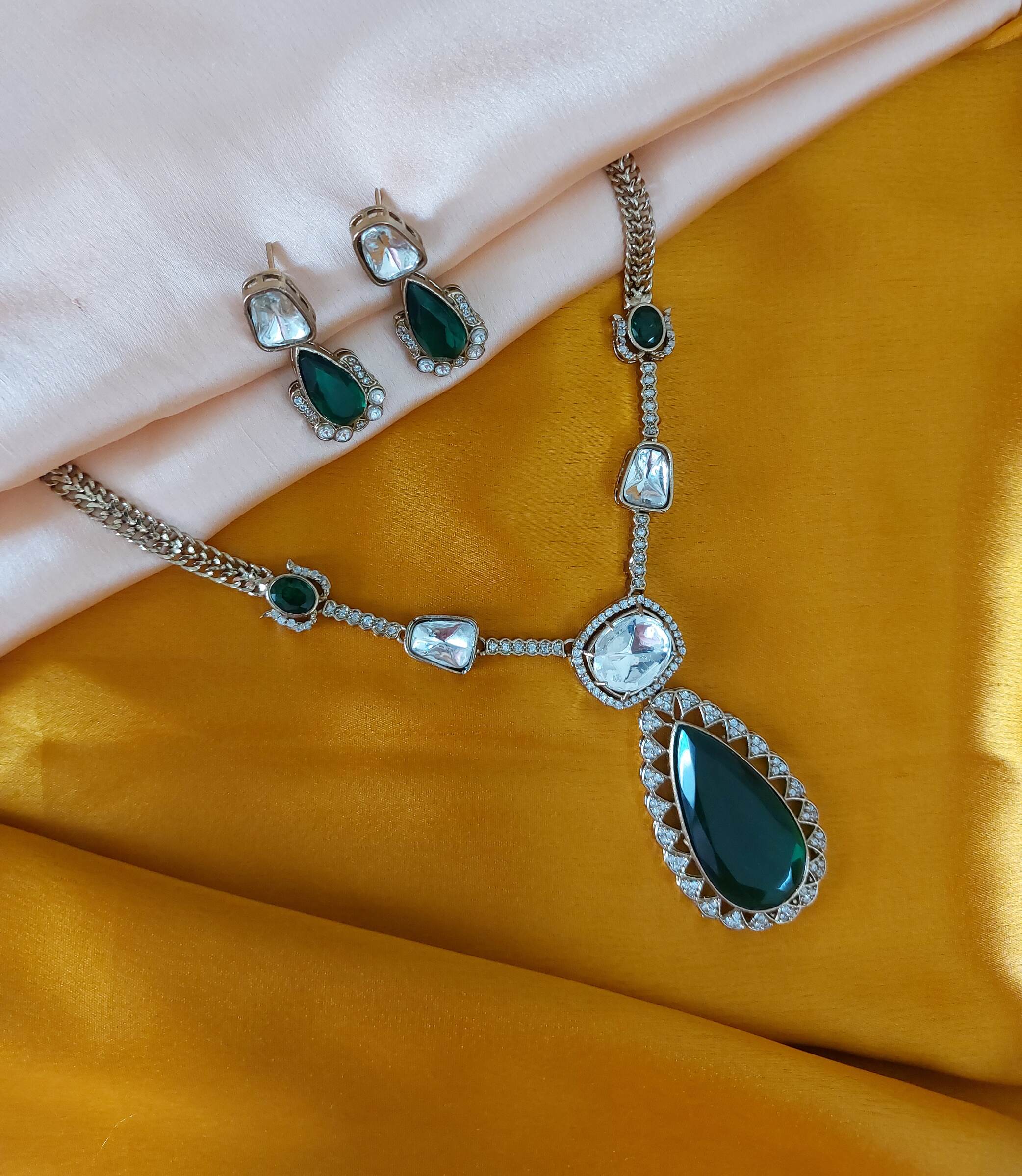 Krisha Moissanite Green Coloured Celebrity Inspired AD Stone Studded Antique Gold Necklace Set With Earrings